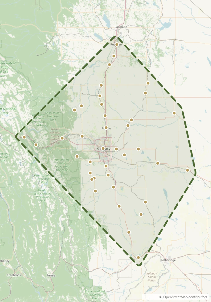 Map showing the White Lily Estate Liquidations service area across southern and central Alberta, outlined from Red Deer to Fort Macleod and Banff to Bassano